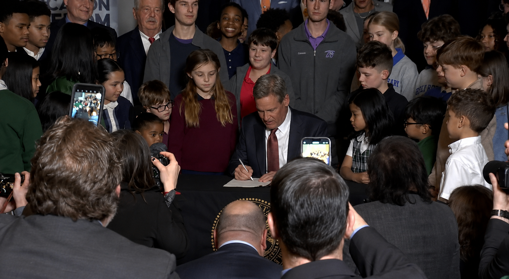 Tennessee Gov. Bill Lee signs the Education Freedom Scholarship Act surrounded by schoolchildren at a State Capitol bill-signing ceremony